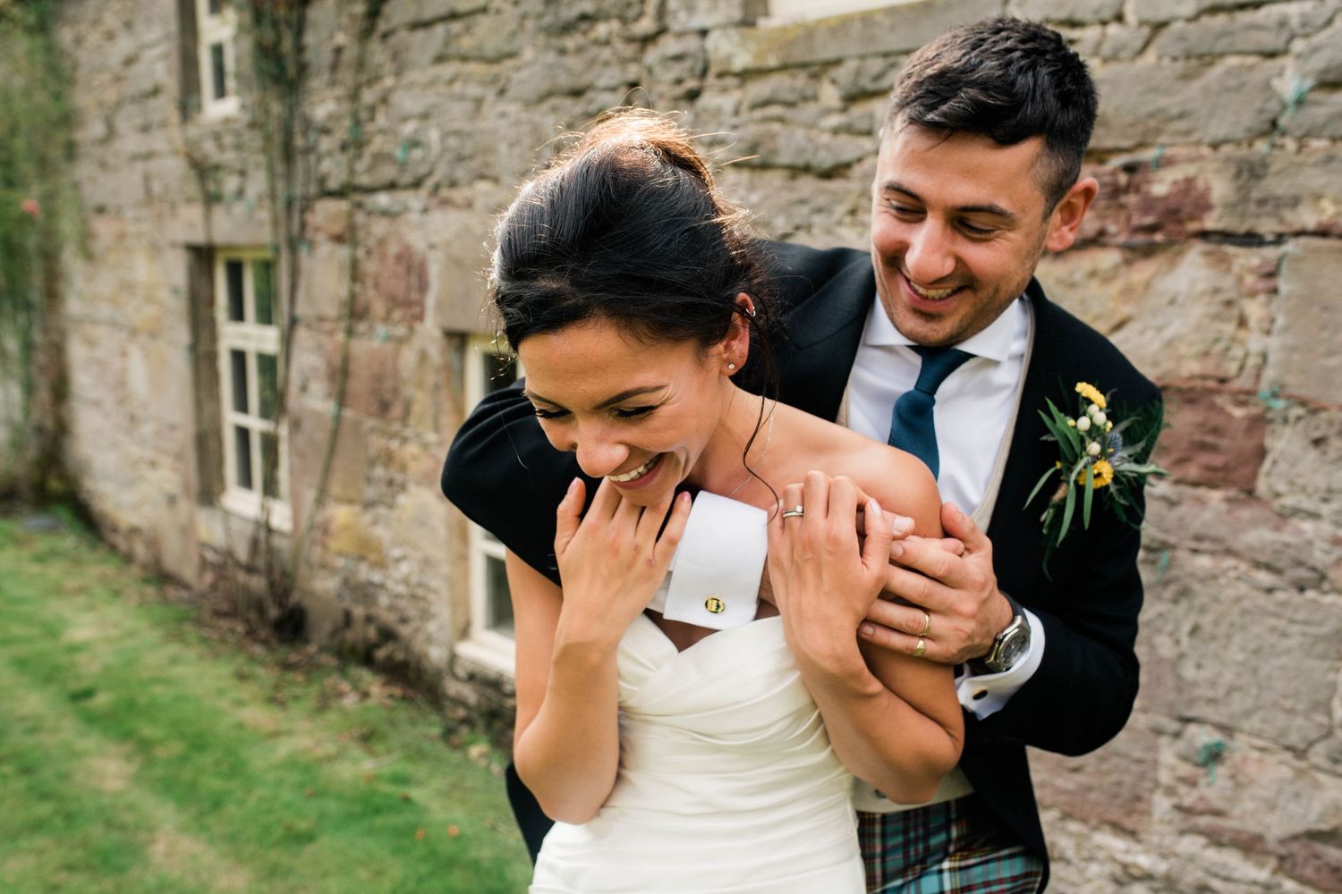 A candid moment of laughter and joy shared during wedding photos.