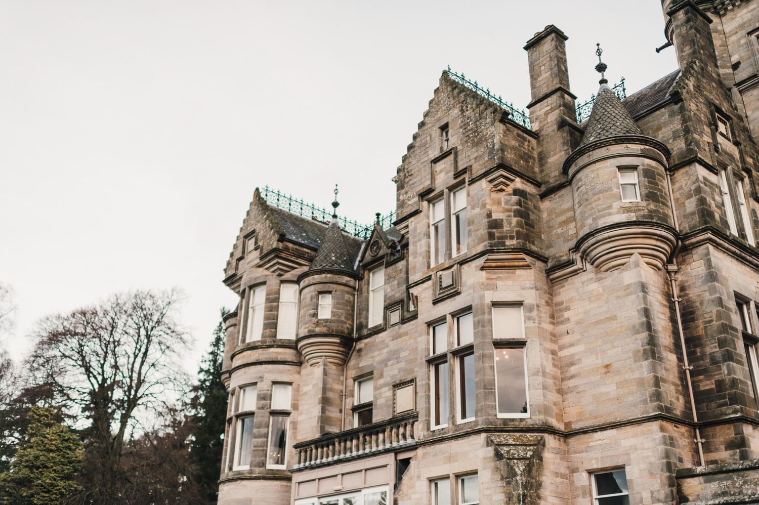 Majestic Scottish baronial style mansion with ornate stone architecture and turrets.