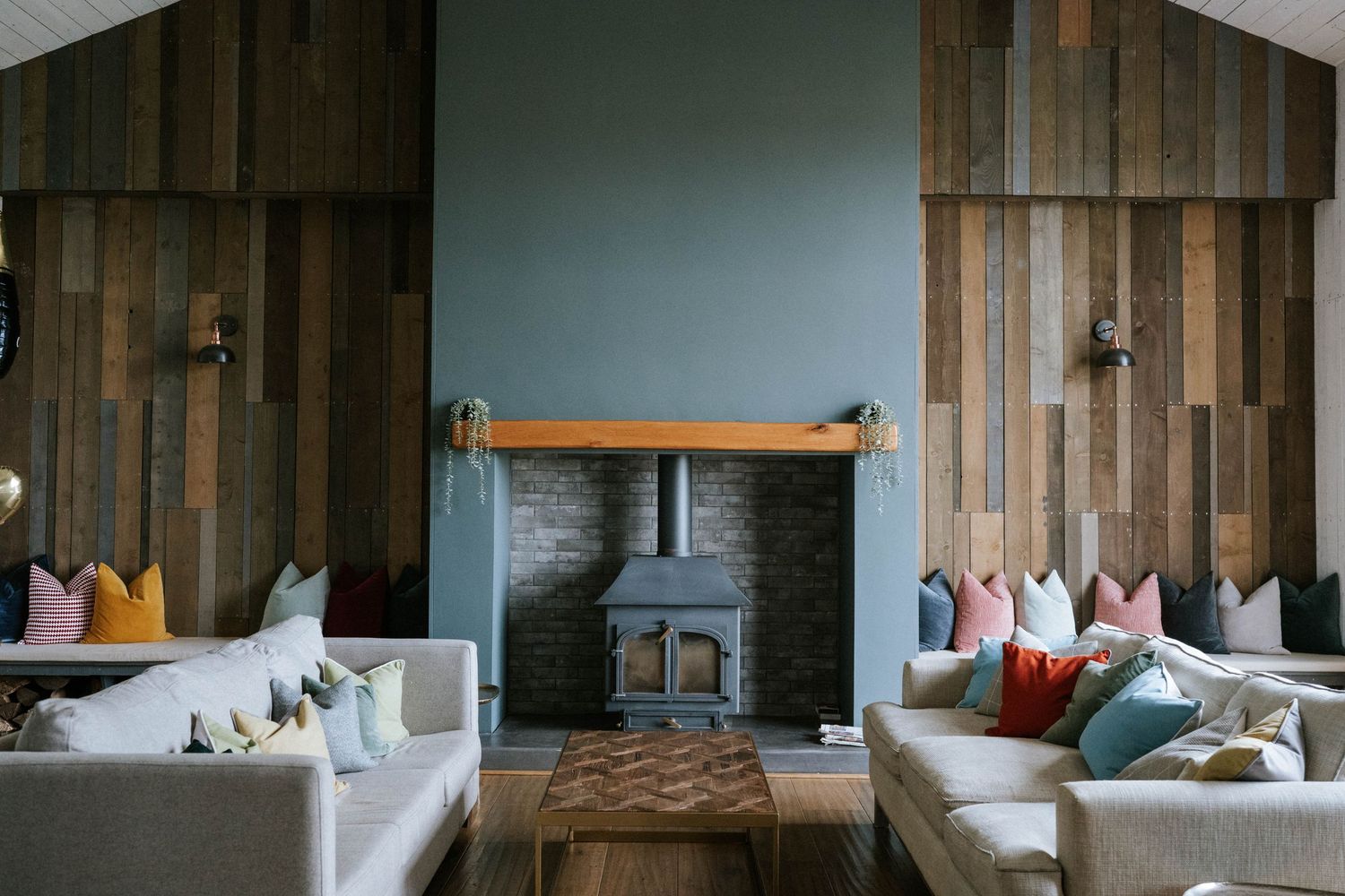 Modern rustic bedroom interior with wooden walls and comfortable bedding.