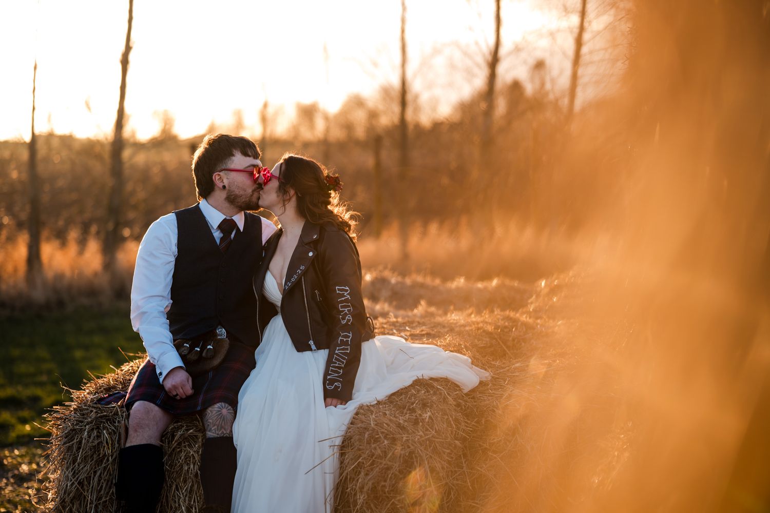 Golden hour wedding photos with warm sunlight filtering through trees as couple shares intimate moments.