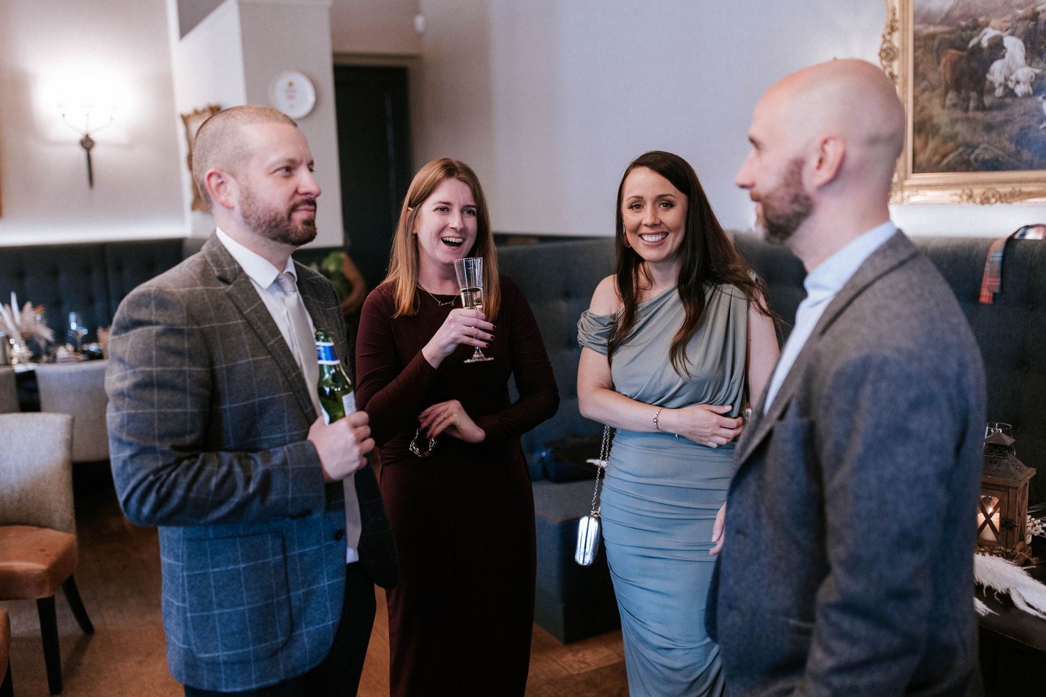 Wedding reception guests mingle and socialize in an elegant indoor venue.