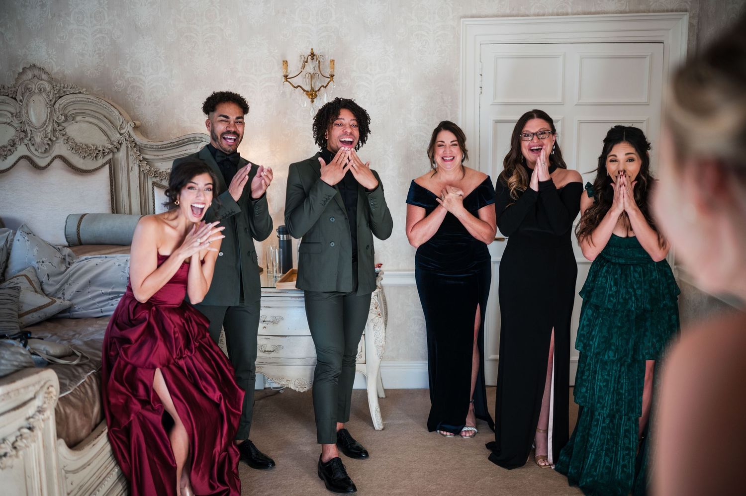 Aberdeen Wedding Photography. Wedding party in burgundy and dark green dresses reacting with excitement.