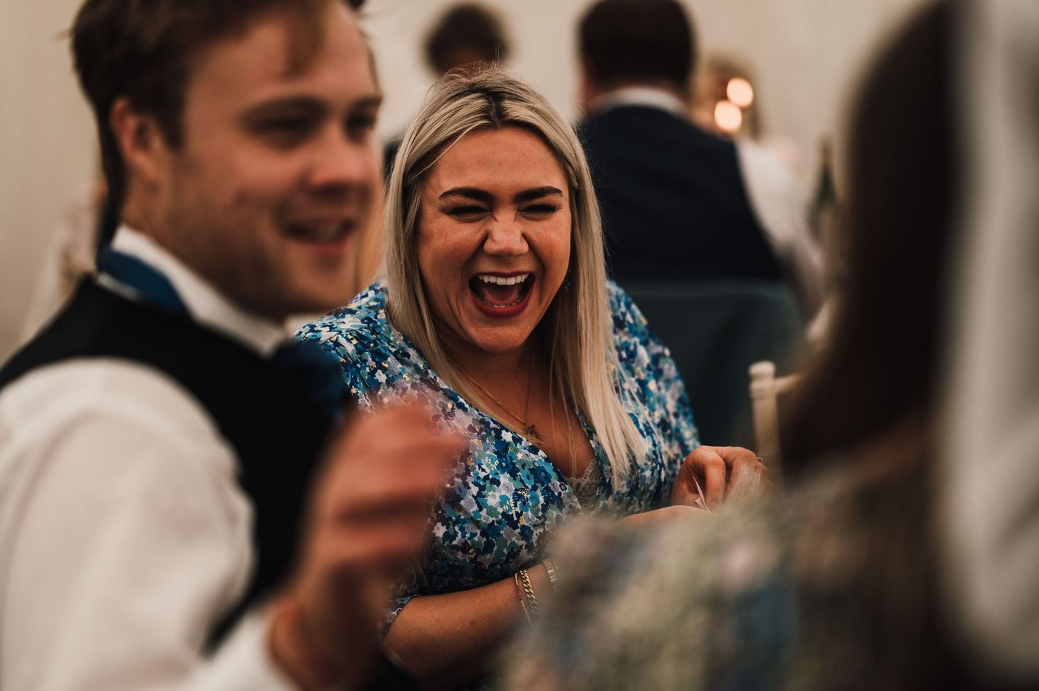 Guests sharing laughter and enjoyment during an elegant evening celebration.