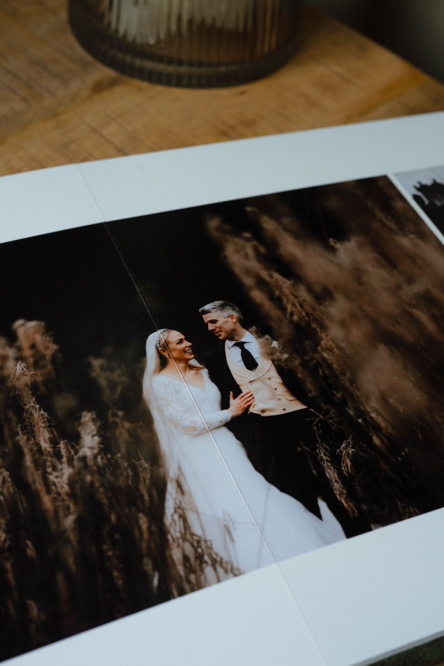 Wedding photo album pages displaying romantic outdoor photography in dramatic lighting.