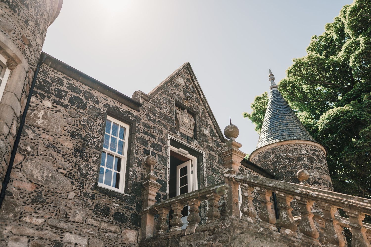 Historic stone building exterior with turrets and traditional Scottish architectural features.