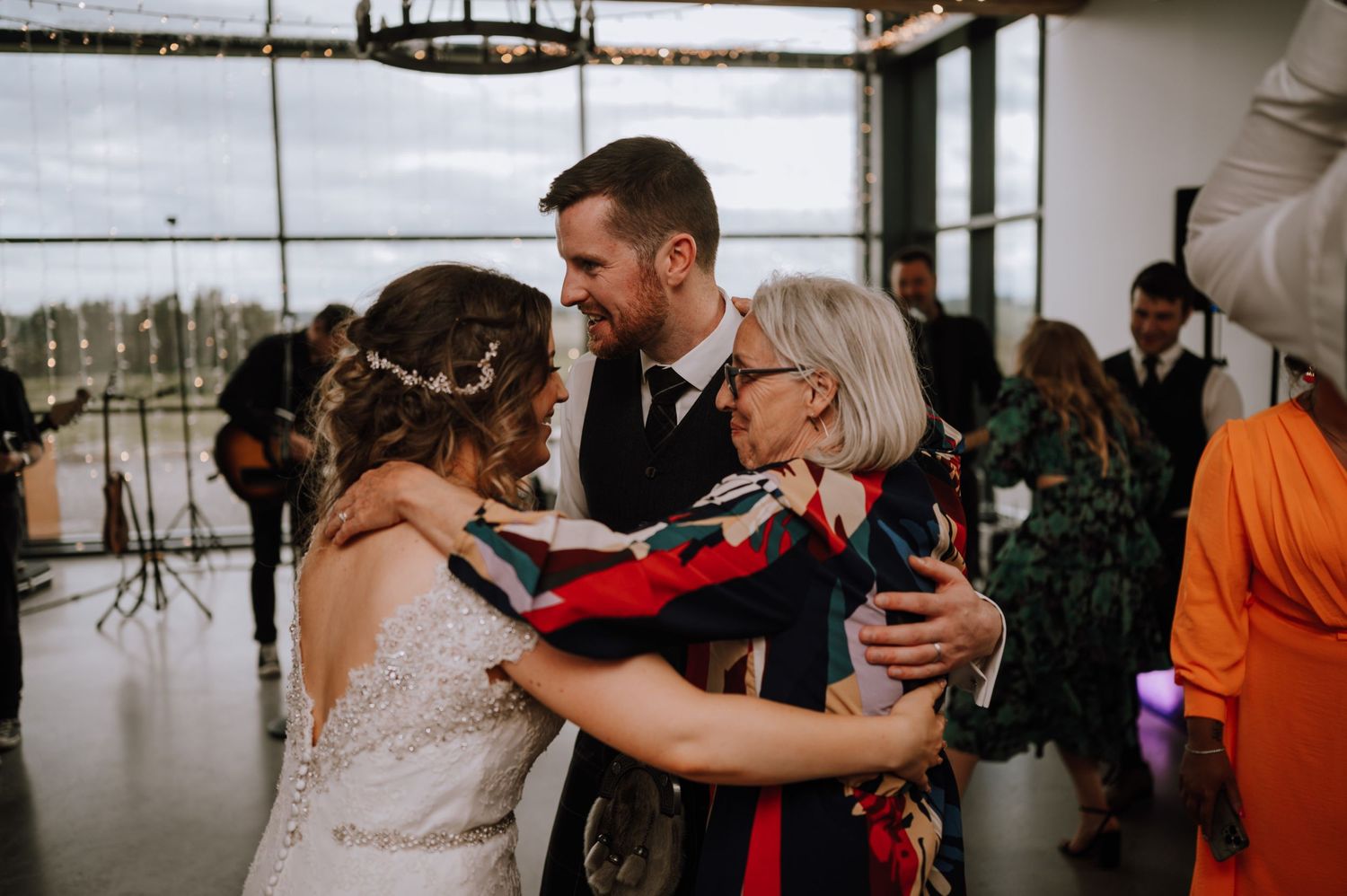 A heartwarming moment shared between people during an emotional wedding celebration.