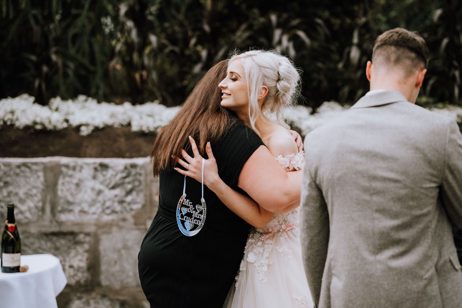 A celebratory moment captured during a greenhouse wedding reception.