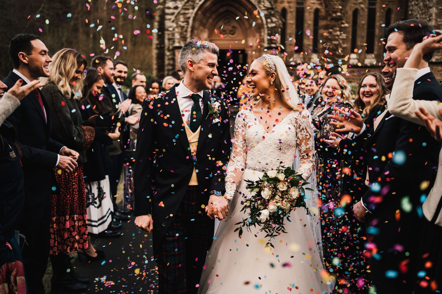Aberdeen Wedding Photography. Joyful wedding exit with colorful confetti being thrown over the newlyweds.
