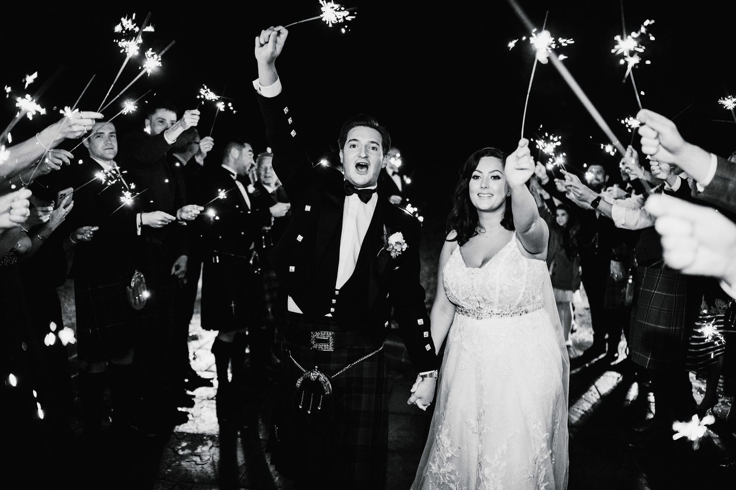 Aberdeen Wedding Photography. Wedding party dancing under dramatic lighting with confetti falling.