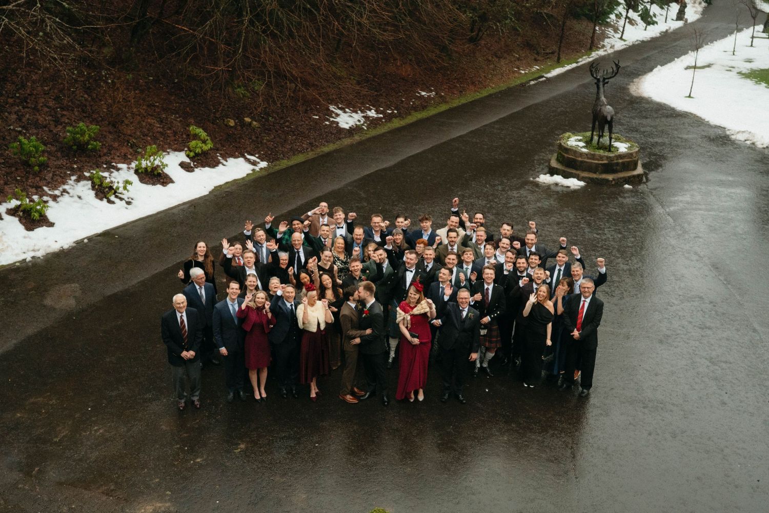 Drumtochty Castle  Wedding Photography. Large group photo of wedding party and guests gathered outside in winter.