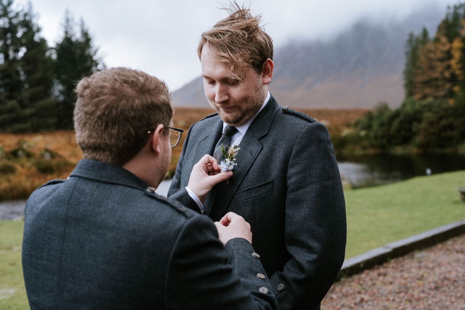 Wedding preparations outdoors with autumn mountains in background.
