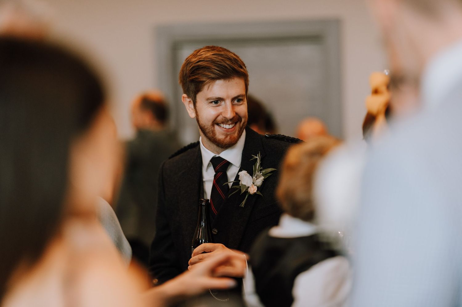 A joyful moment captured during a wedding celebration with guests in formal attire.