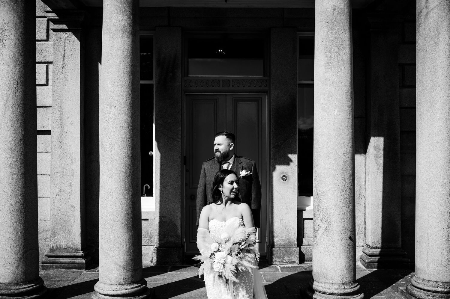 Aberdeen Wedding Photography. Elegant white columns frame a classic architectural wedding venue entrance.