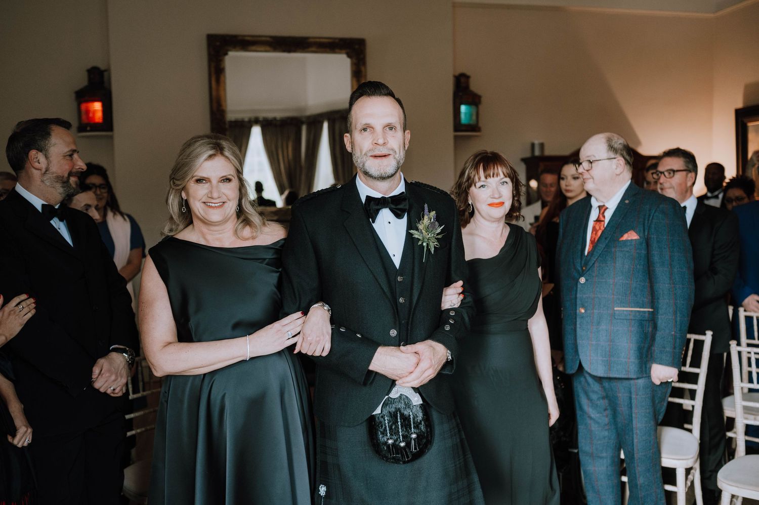 Logie House Wedding Photography. Wedding reception guests dance and celebrate in a dimly lit indoor venue.