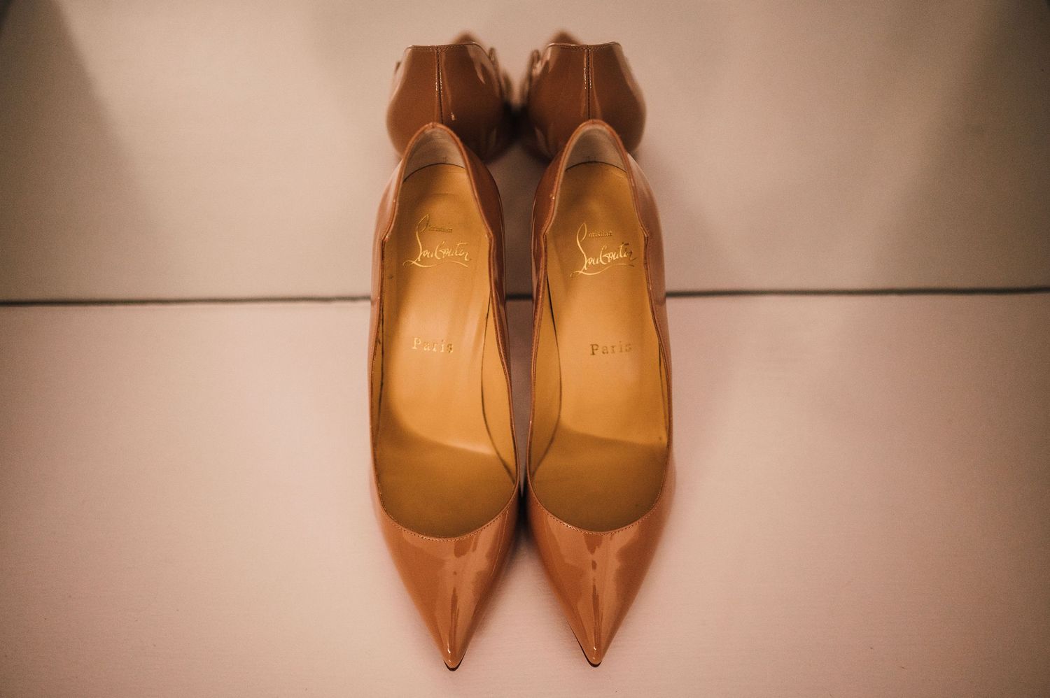 Elegant nude and tan colored high heeled shoes arranged in a row.