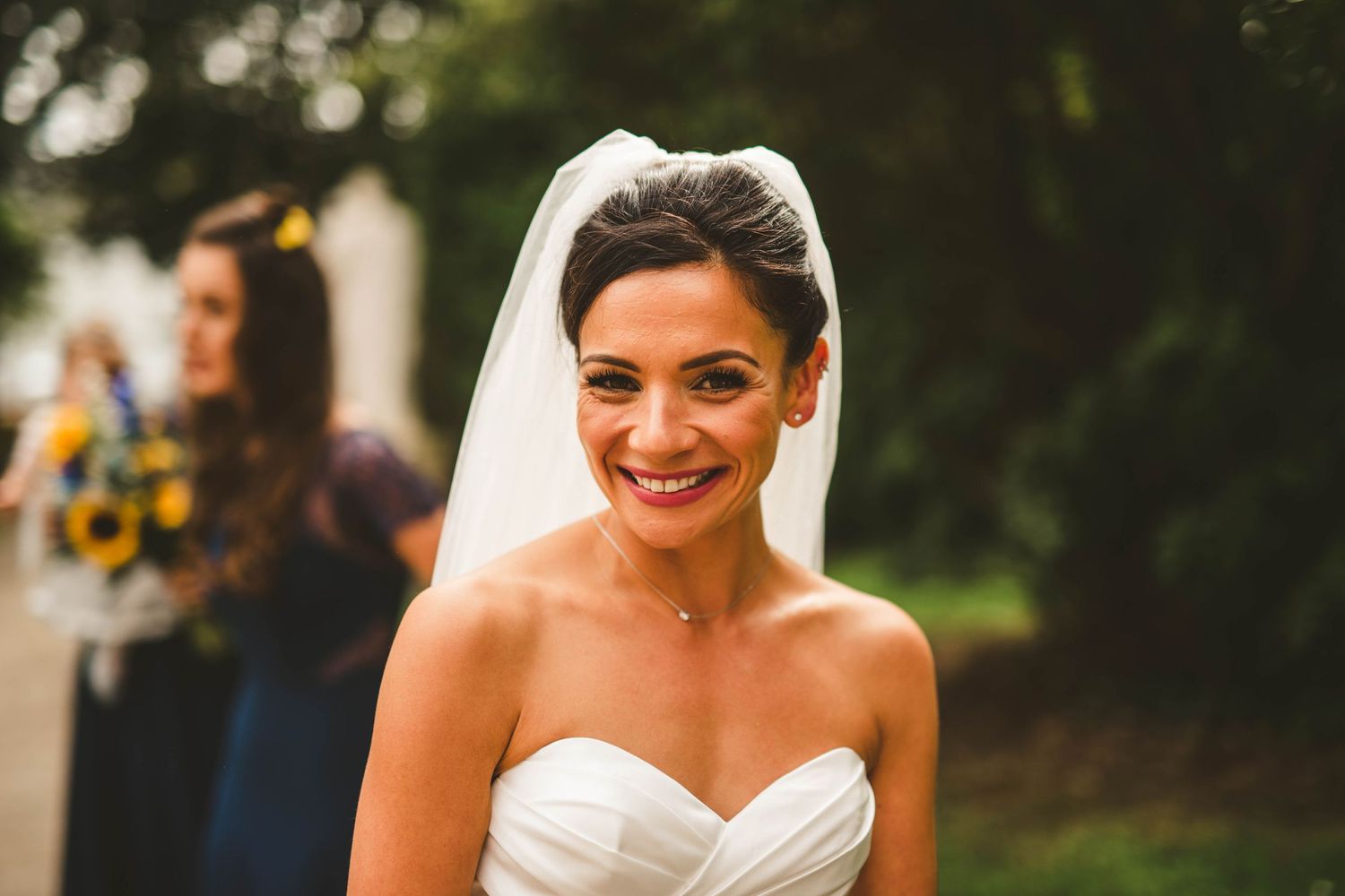 A joyful moment captured during a sunny outdoor wedding celebration.