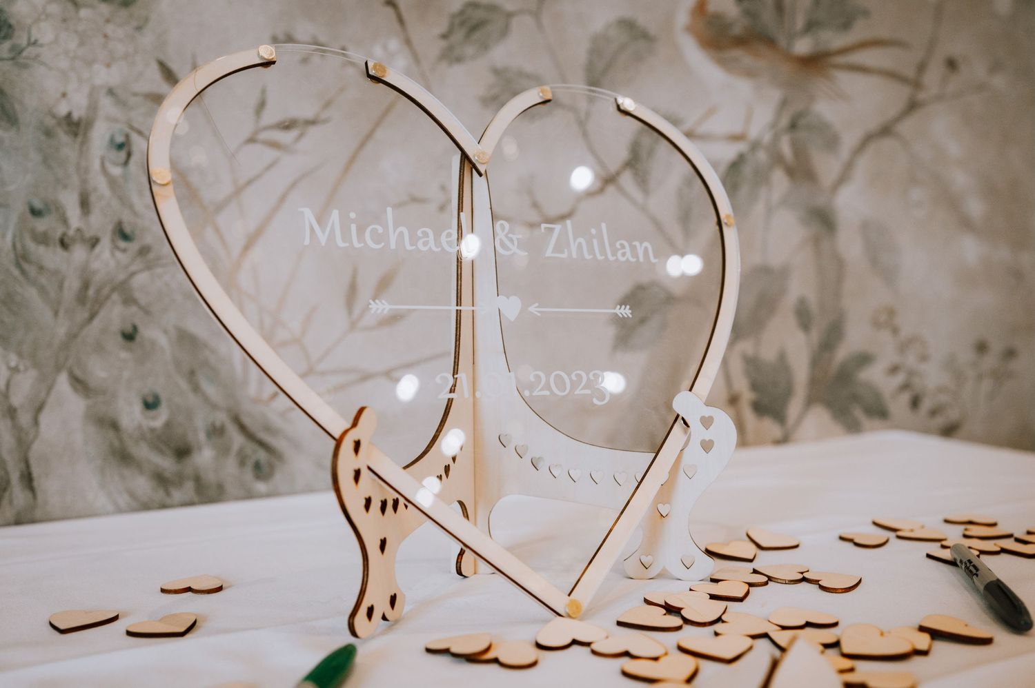 Heart-shaped wooden guest book alternative with small wooden hearts.