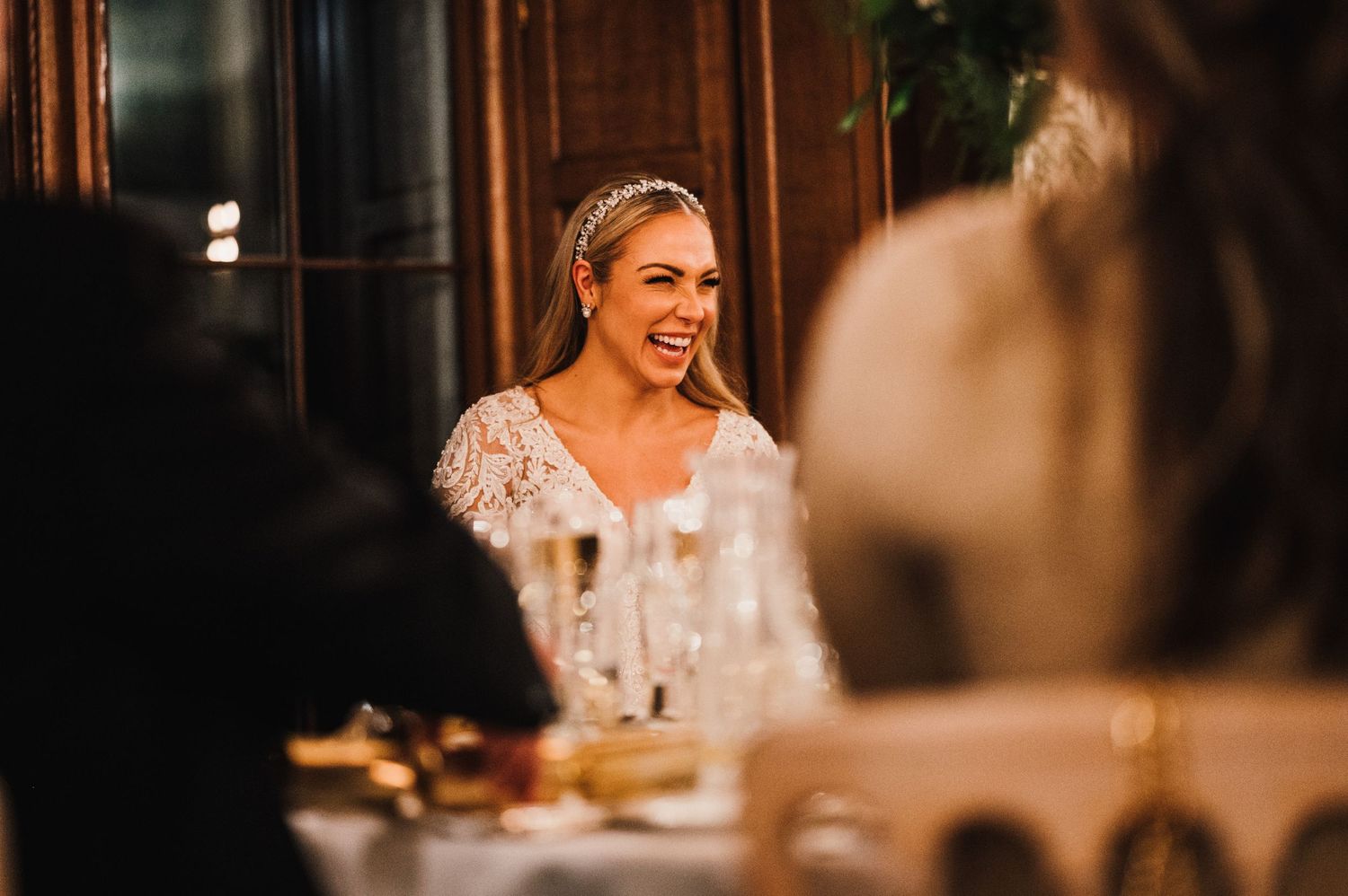 Guest enjoying laughter and conversation during elegant evening wedding celebration.