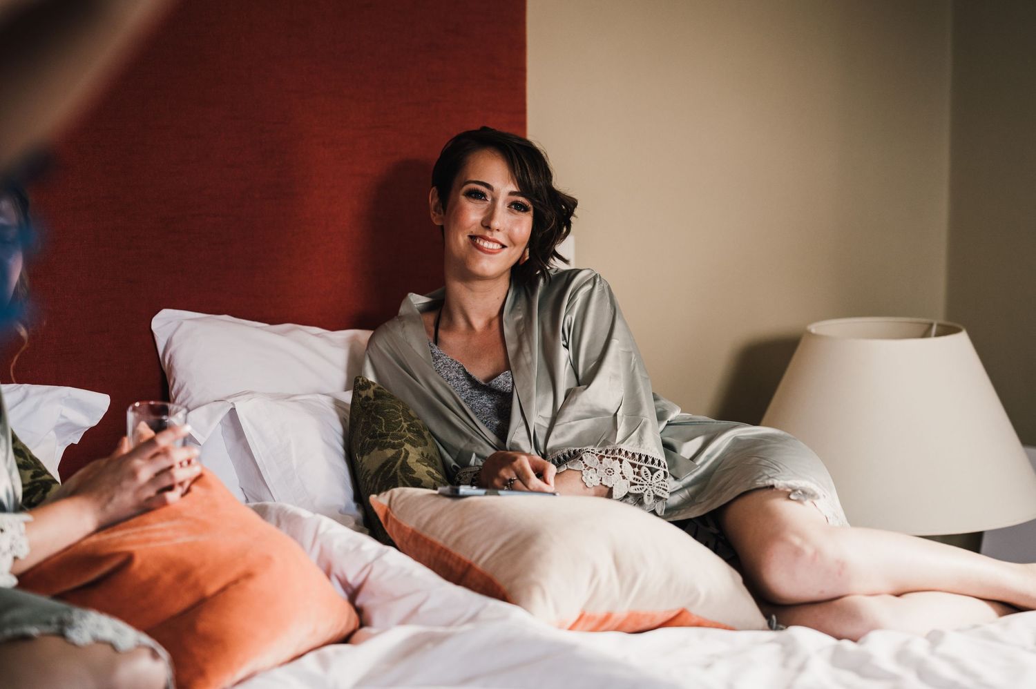 A relaxed morning scene in a bedroom with soft lighting and comfortable bedding.