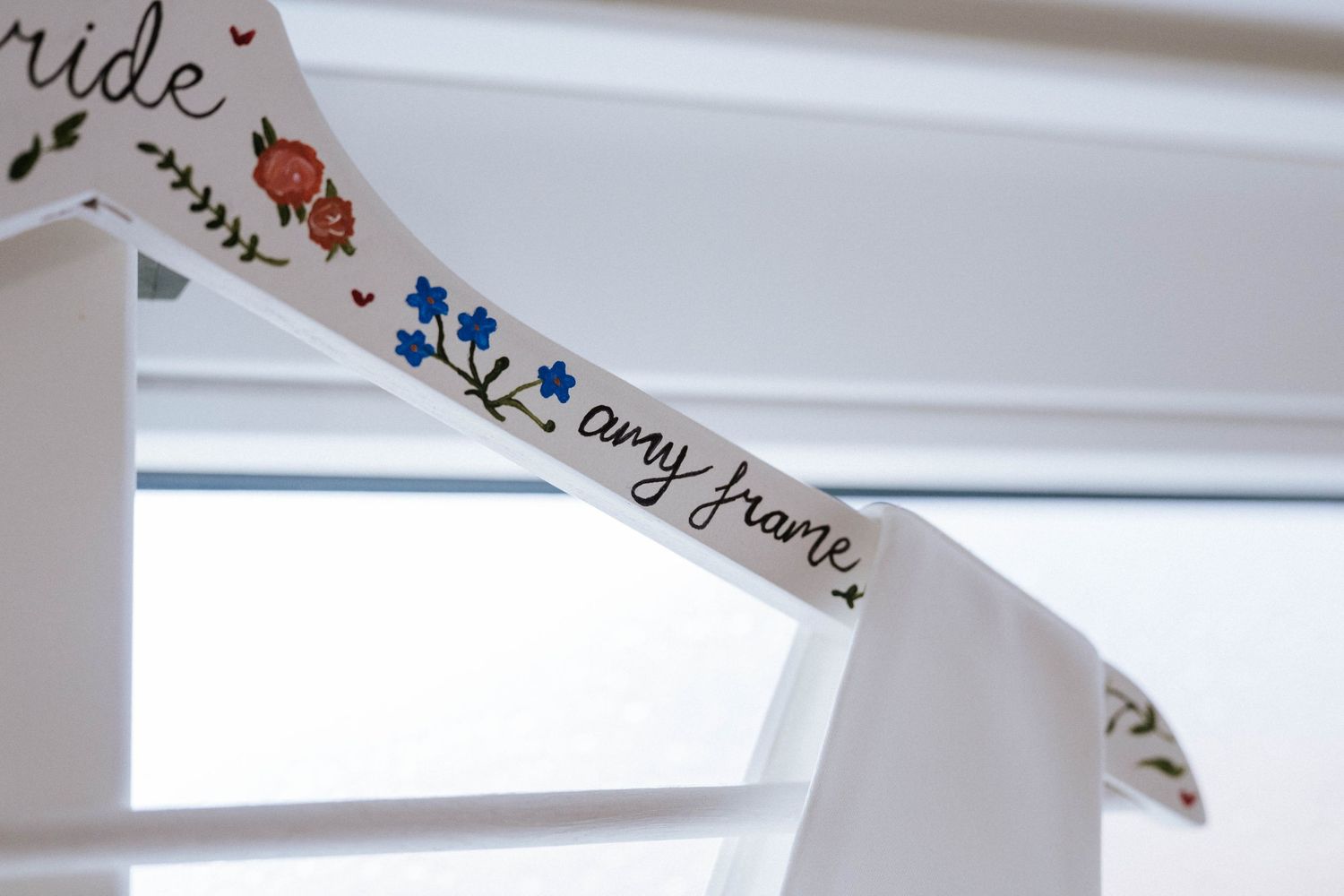 Decorative paper banners with handwritten text hanging against a white background.