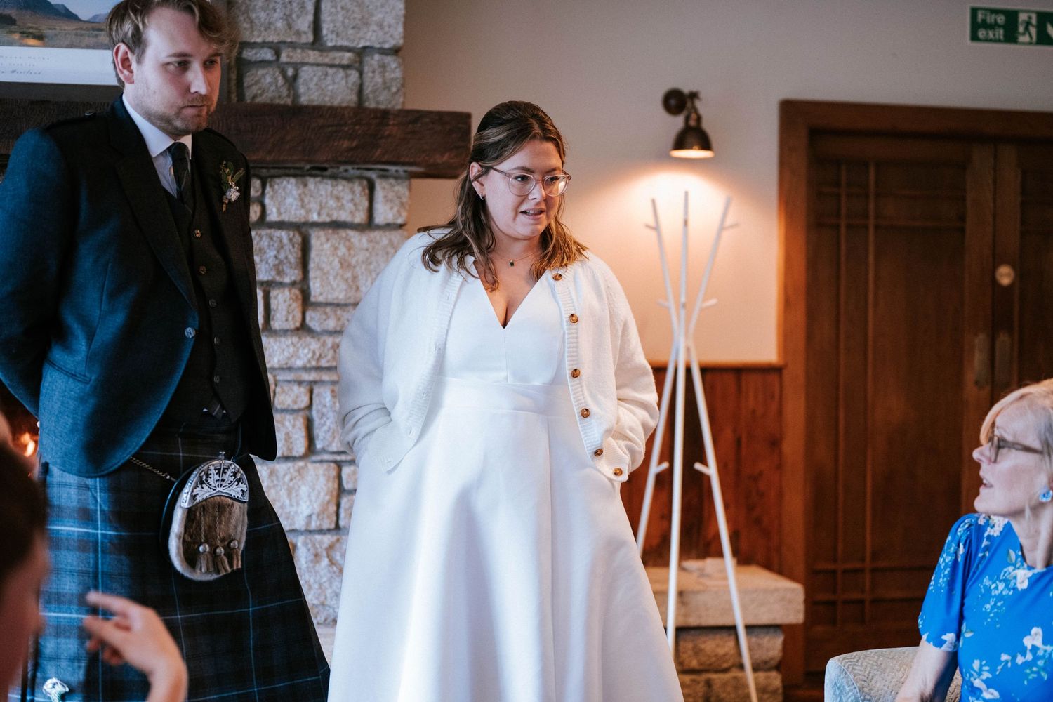 Wedding celebration in a rustic stone-walled venue with warm lighting and elegant decor.