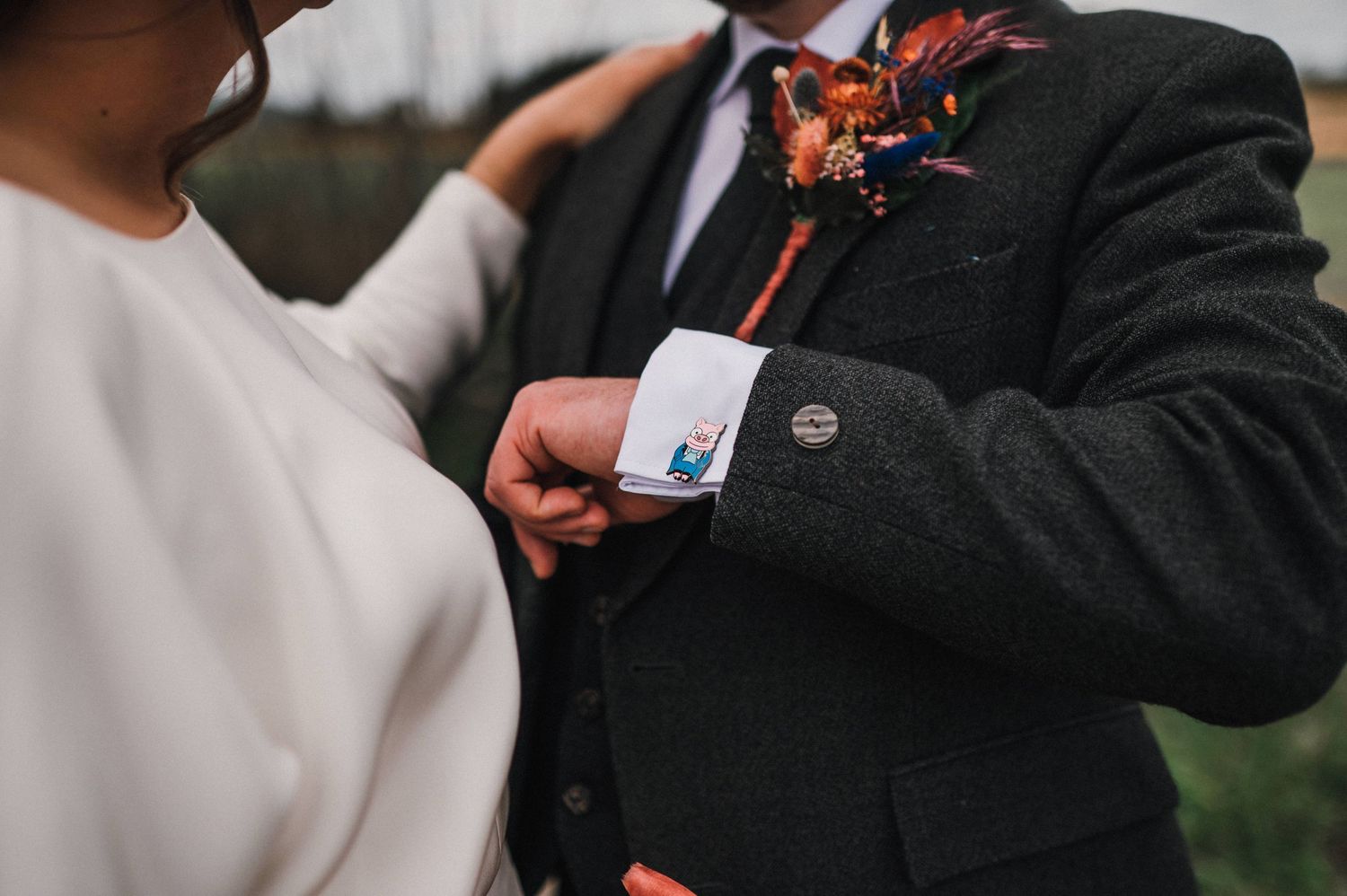 Close-up detail of traditional Scottish wedding attire showing boutonniere and formal jacket.
