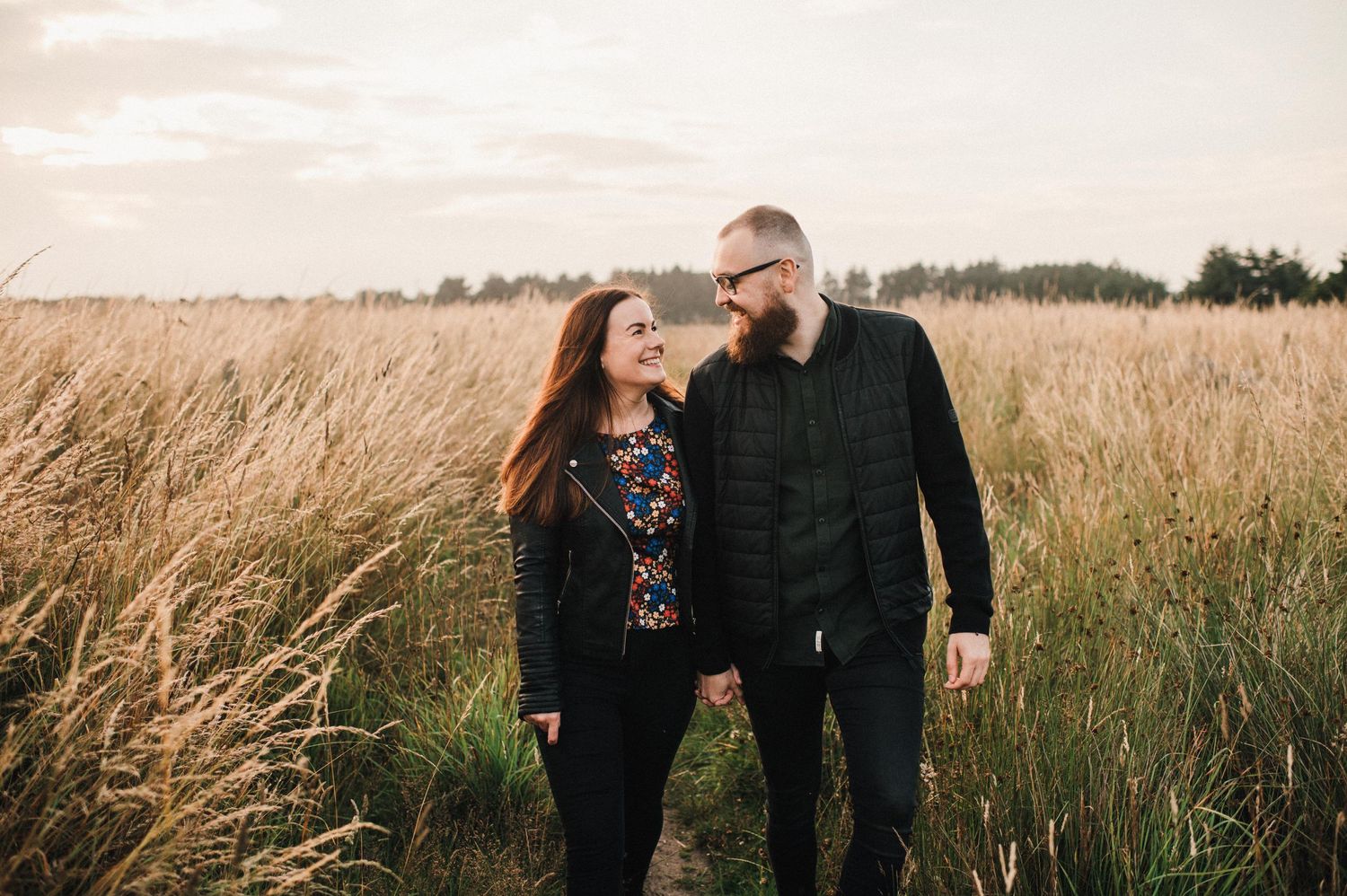 Walking together through rustic field with natural golden light.