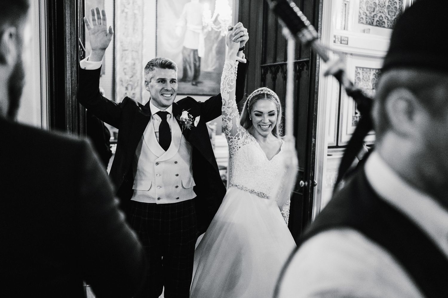 A celebratory moment captured in black and white during a formal wedding celebration.