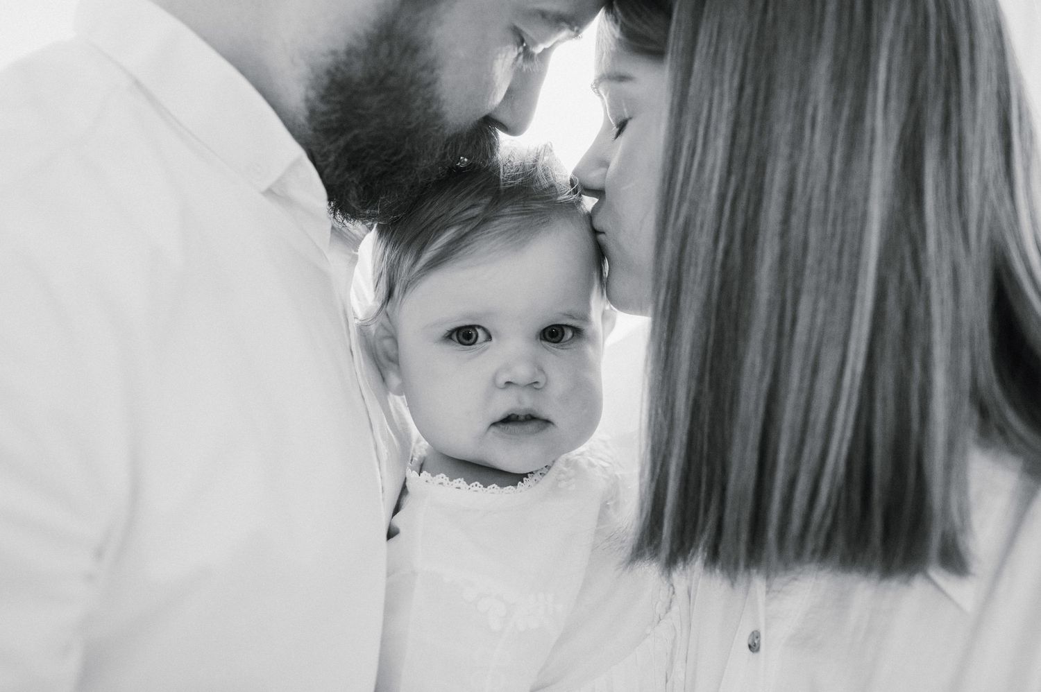 Intimate black and white family portrait series capturing emotional connections and gentle interactions.