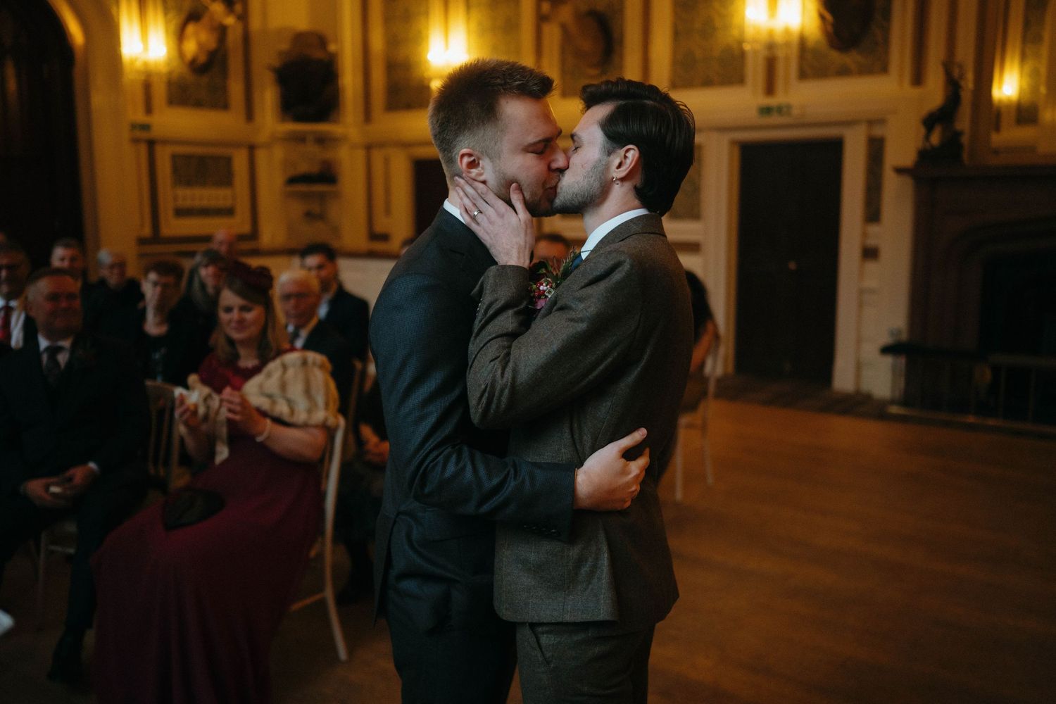 Elegant indoor celebration in a warmly lit ballroom with ornate architectural details.