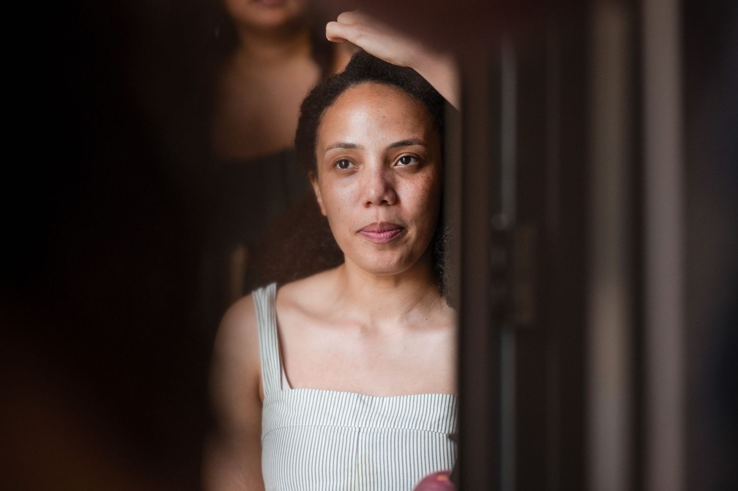 Portrait style photos in a dark indoor setting.