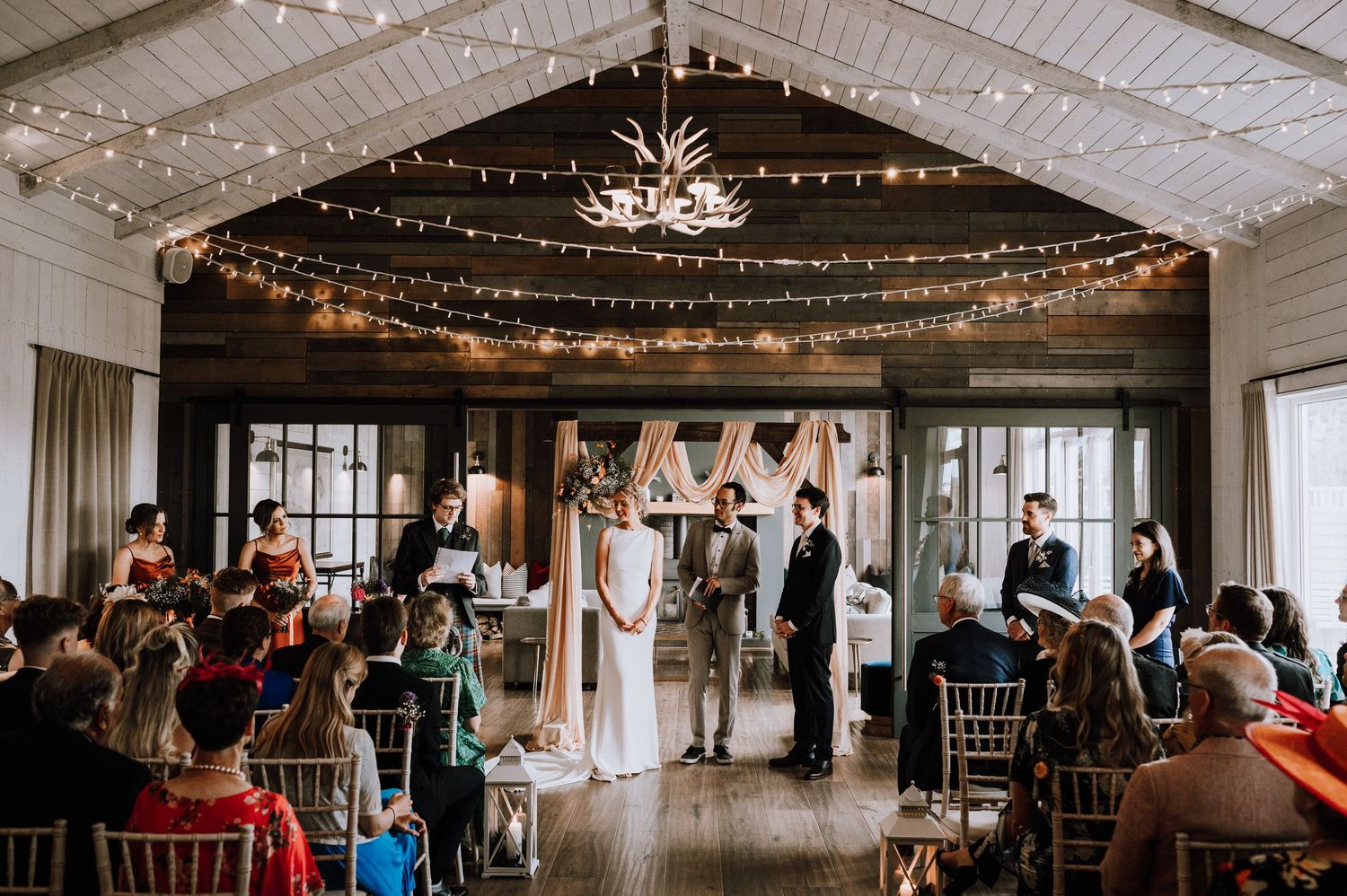 Aberdeen Wedding Photography. Wedding reception venue with white ceiling, string lights and elegant table settings.