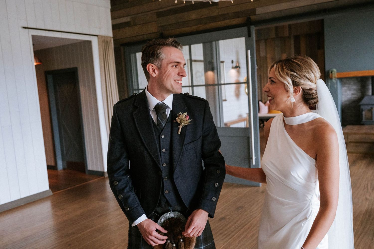 Wedding party dancing and celebrating in an elegant indoor venue.