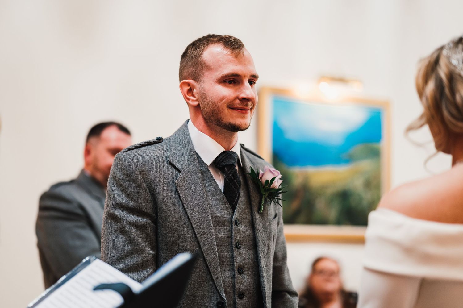 Wedding guests enjoying conversation during reception in elegant indoor setting.