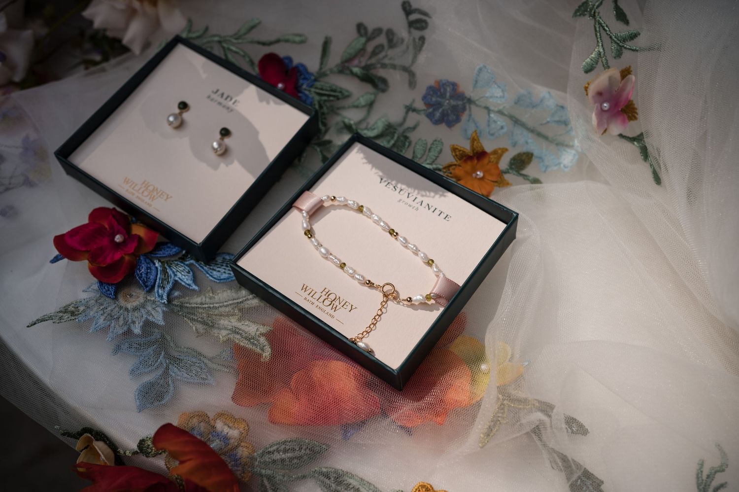 Close-up shots of floral wedding stationery and invitations on a light surface.