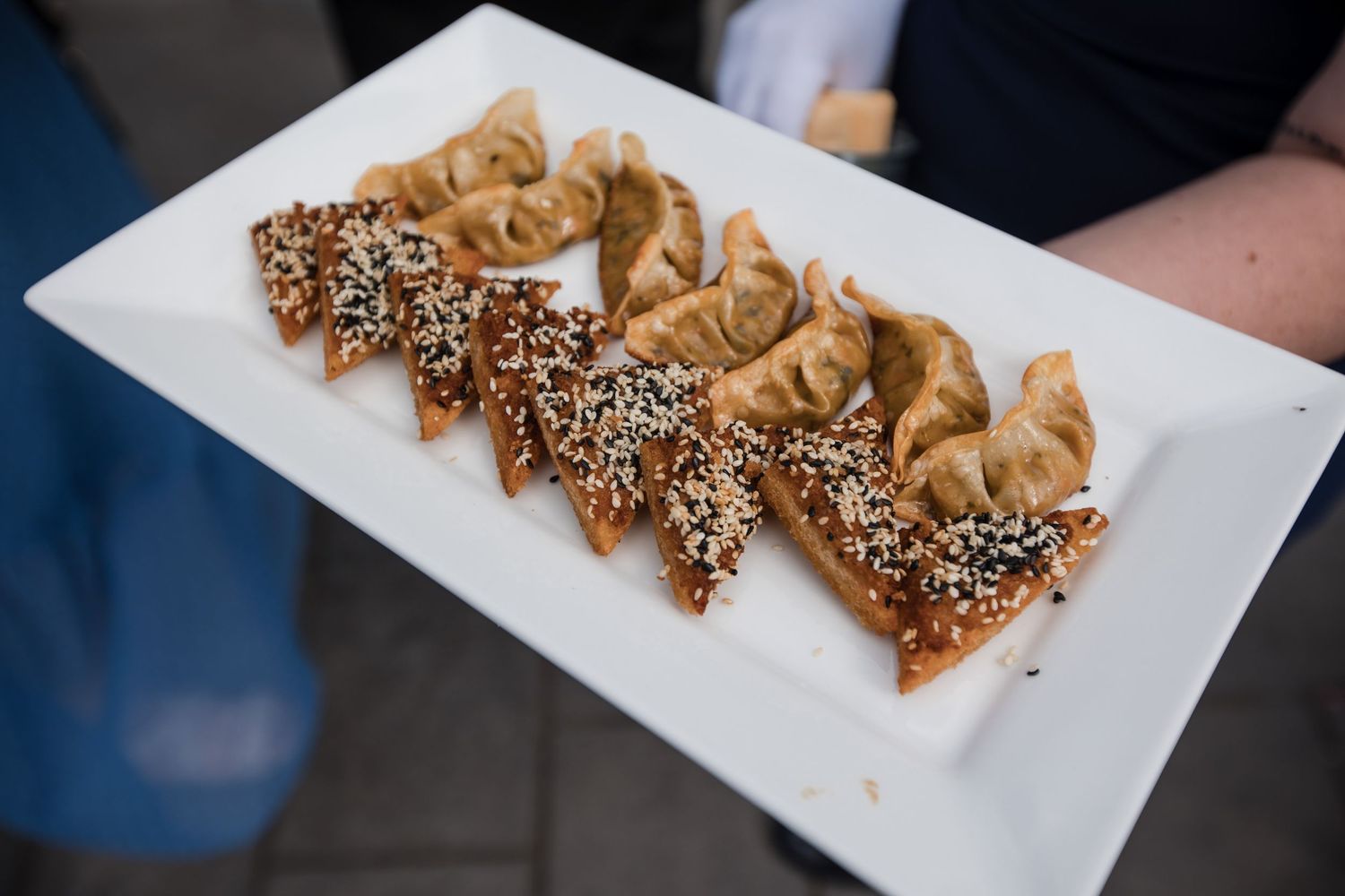 Plate of decorative pastries with sesame seeds served at a wedding reception.