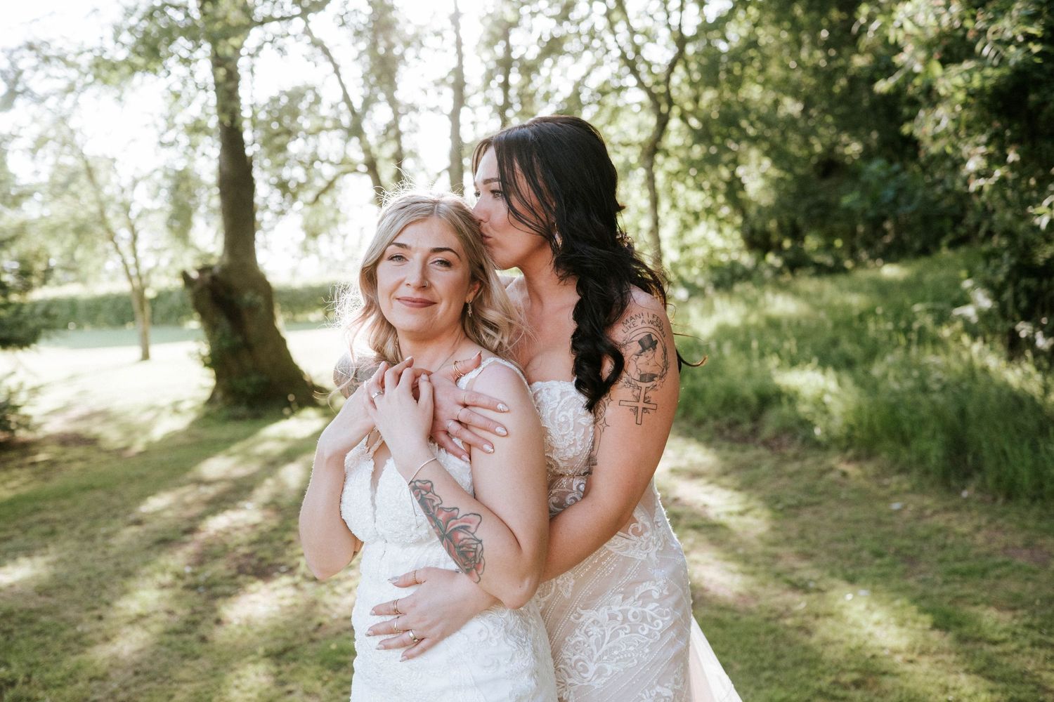 Fasque Castle Wedding Photography. Wedding party poses in natural sunlight among trees and greenery.