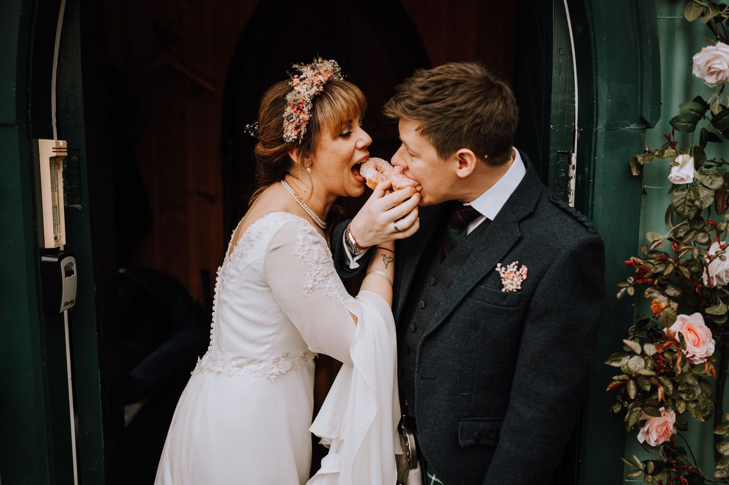 Romantic wedding moment captured outdoors with floral decorations.