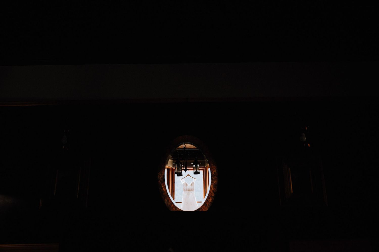 A dim lantern glows warmly in dark surroundings.