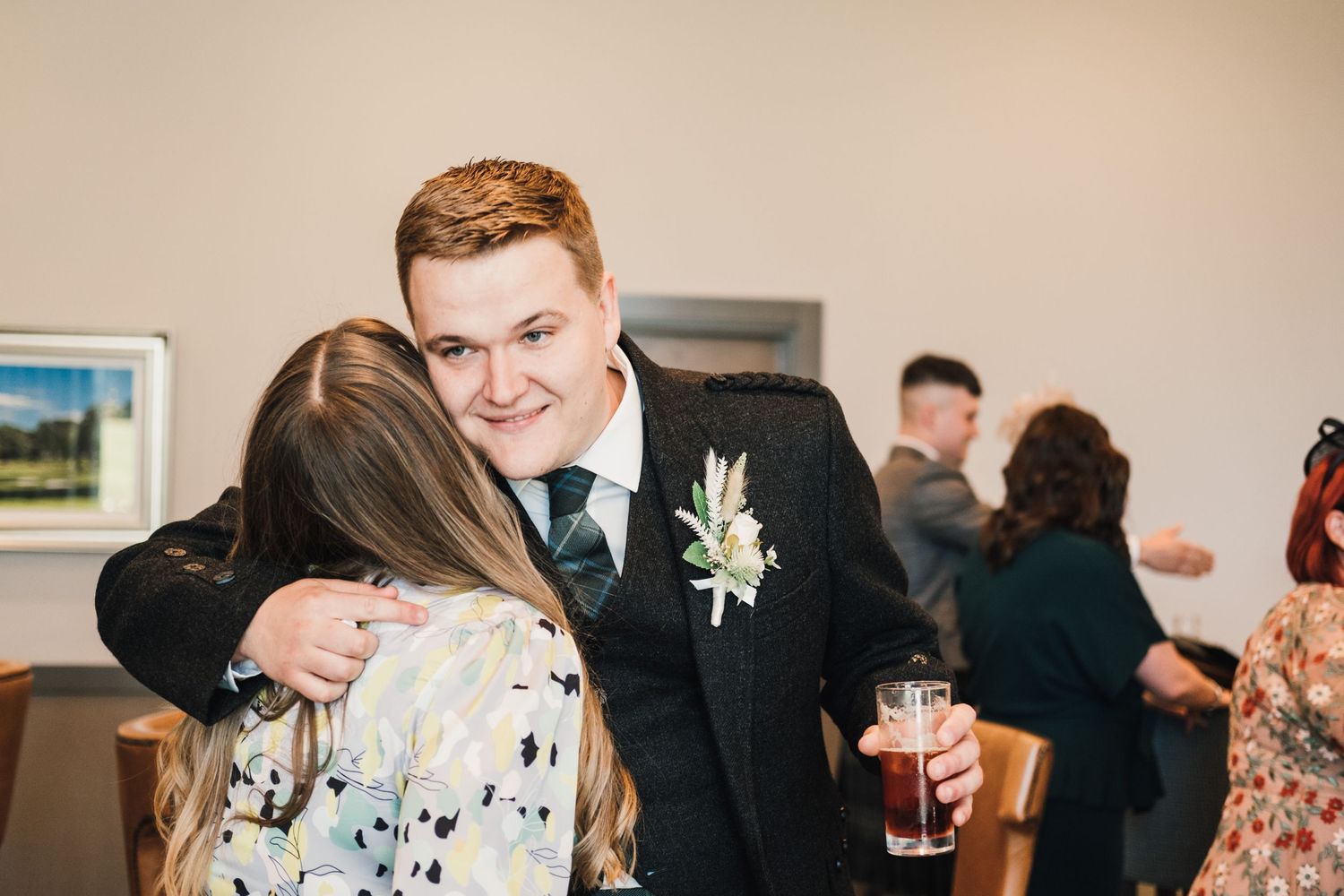 Wedding reception celebration with joyful guests sharing embraces.
