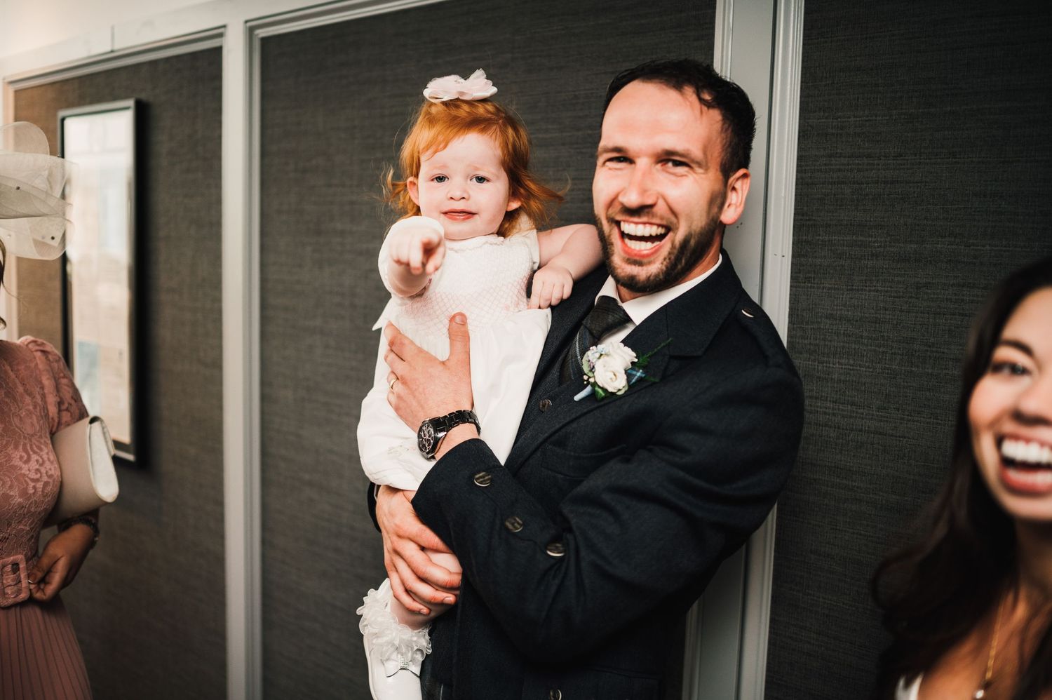 A joyful wedding celebration moment captured in a hallway.