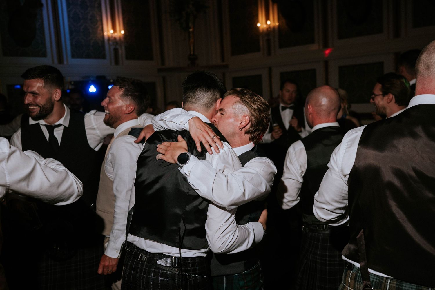 Guests forming a circle during an energetic wedding reception dance.
