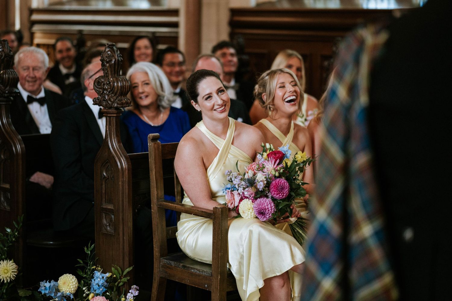 Wedding guests share laughter and joy during the ceremony.