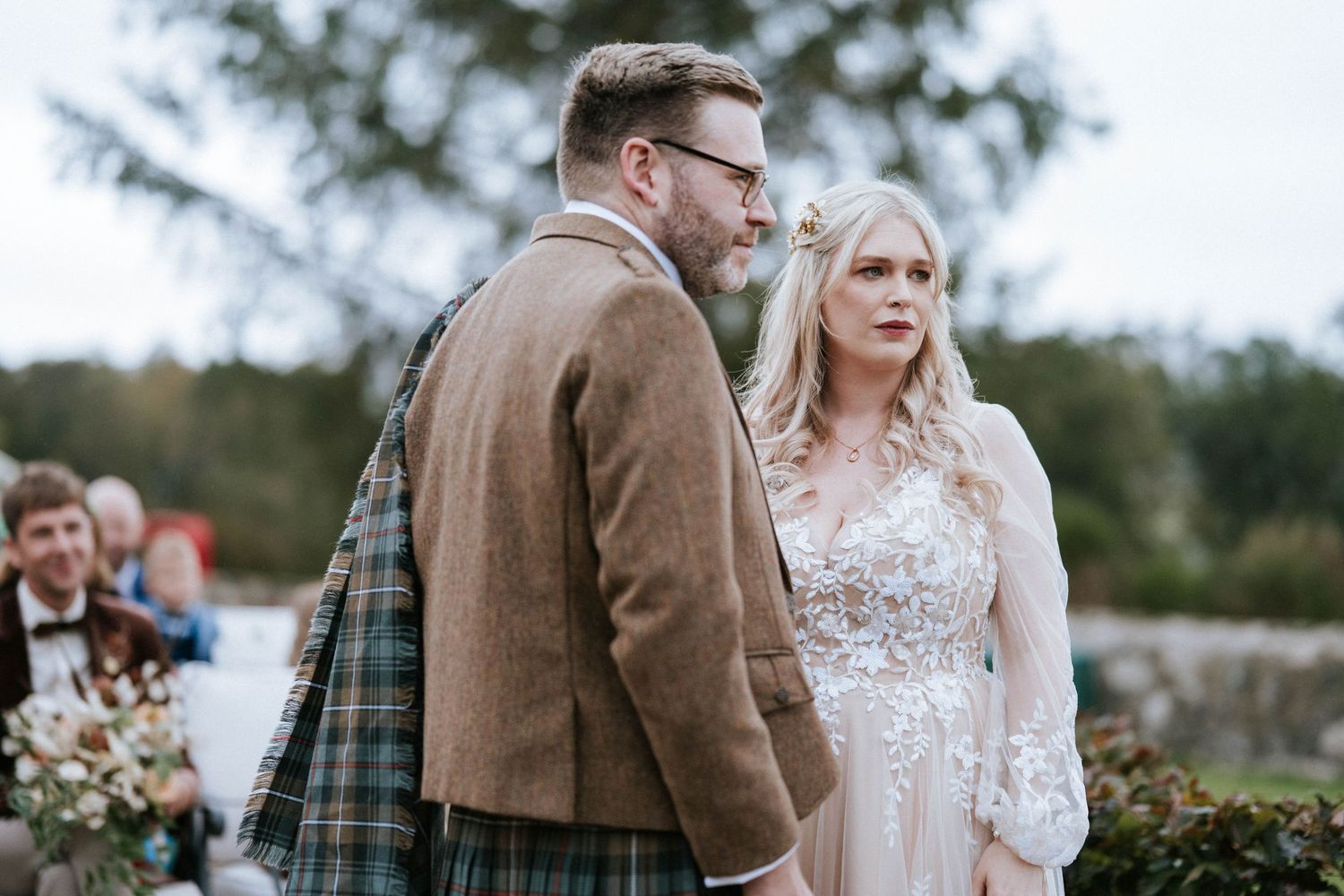 Elegant outdoor wedding ceremony with Scottish tartan details and lace wedding dress.