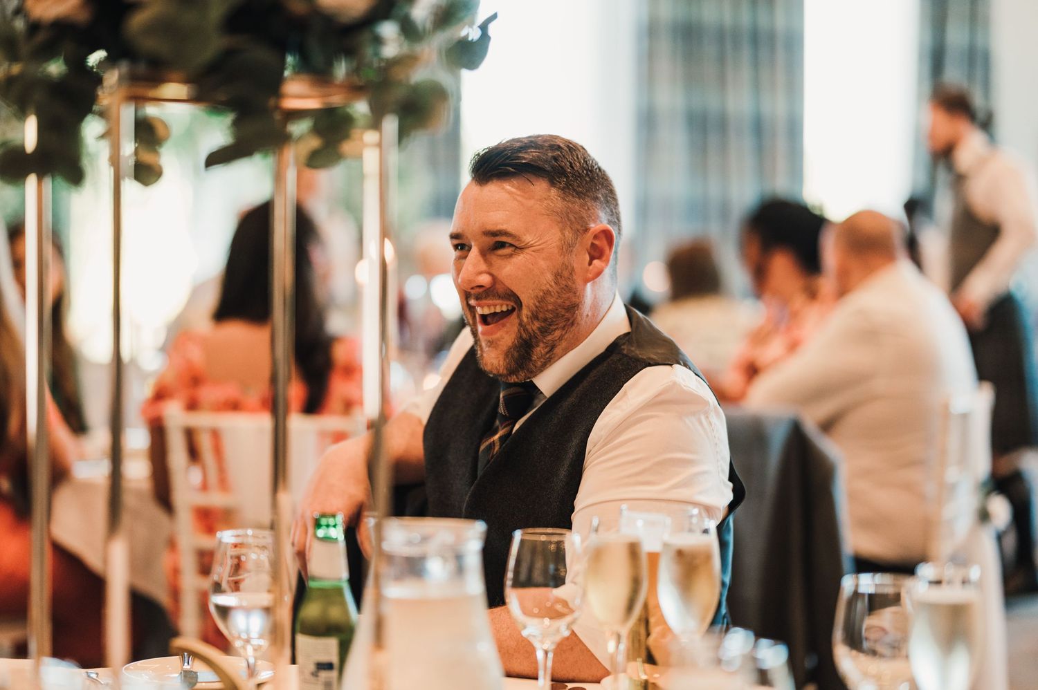Guest enjoying drinks and conversation at an elegant wedding reception.