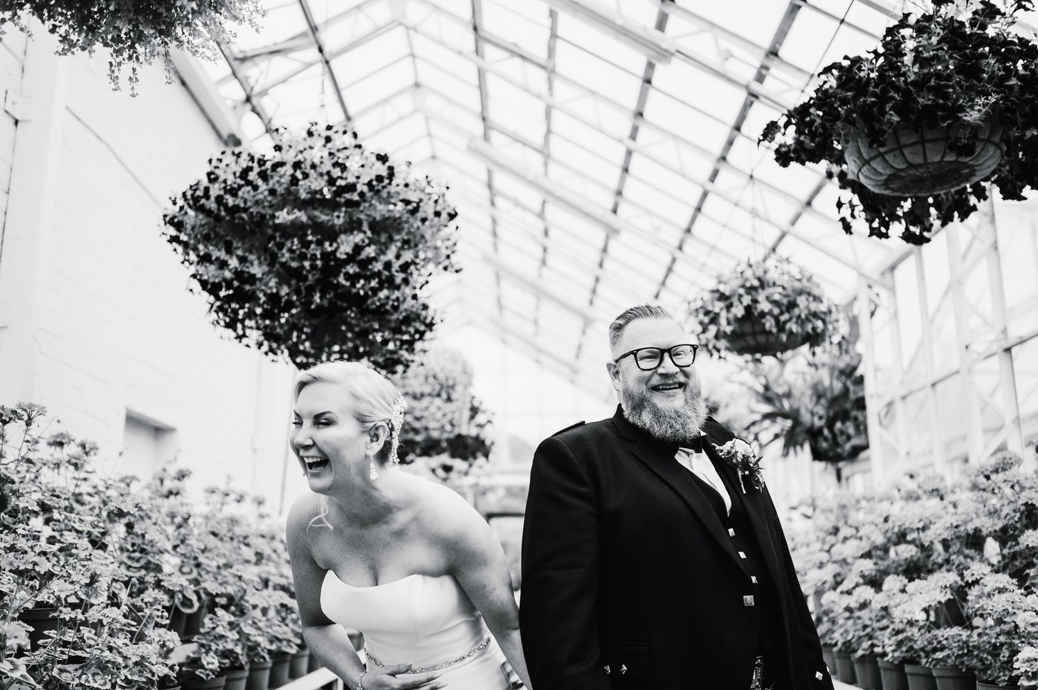Aberdeen Wedding Photography. Wedding reception in a greenhouse with natural light streaming through glass ceiling.