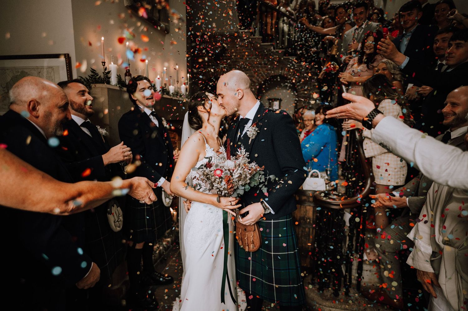 Aberdeen Wedding Photography. Wedding celebration with confetti flying through the air during a joyous moment.