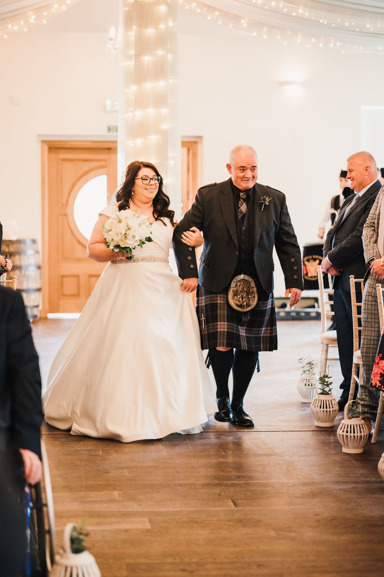 Logie House Wedding Photography. Wedding reception hall decorated with string lights and lanterns on hardwood floors.