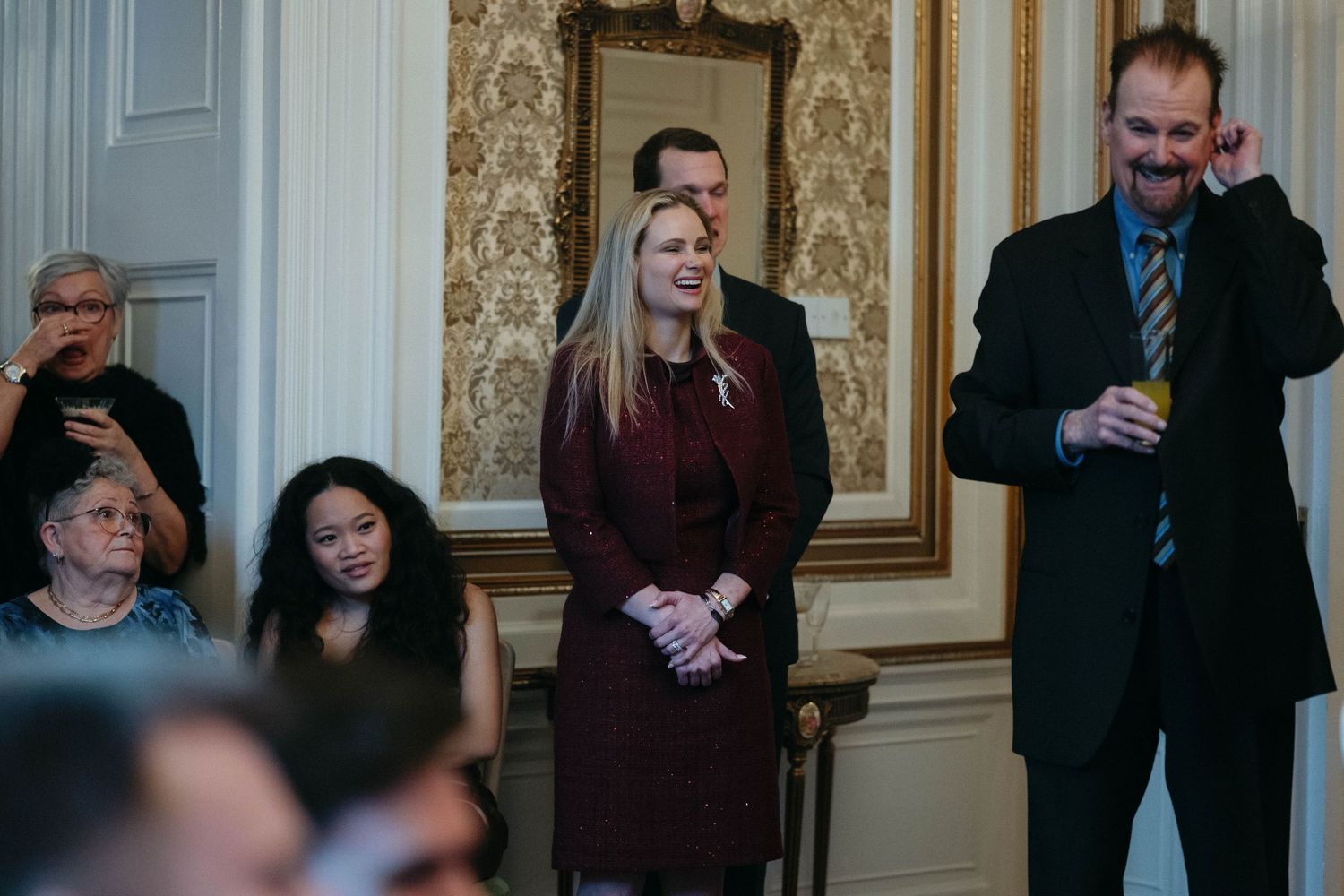 Drumtochty Castle  Wedding Photography. Audience members watching and smiling during a formal gathering in an elegant interior.