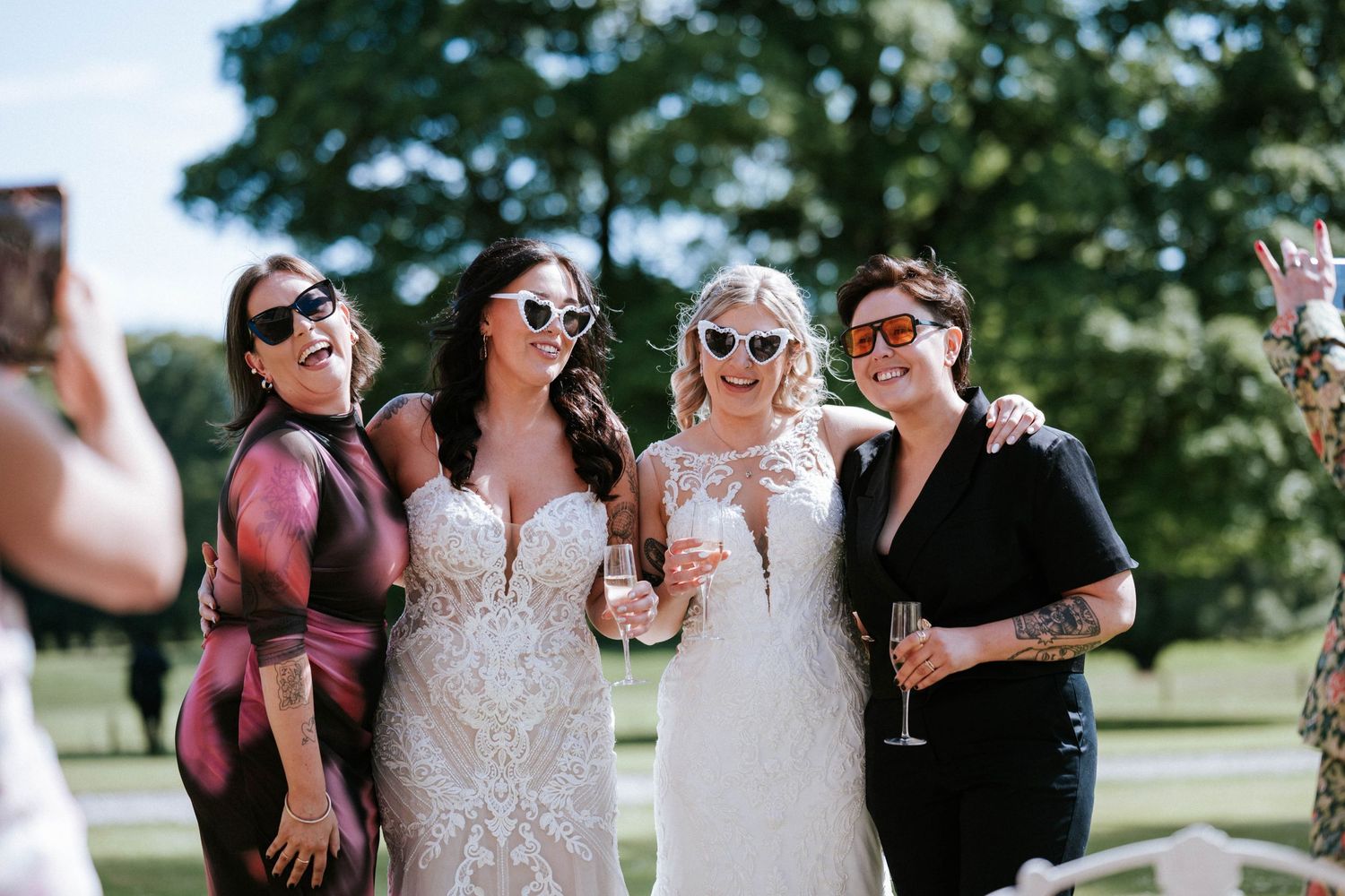 Aberdeen Wedding Photography. Wedding party wearing sunglasses poses together outdoors on a sunny day.